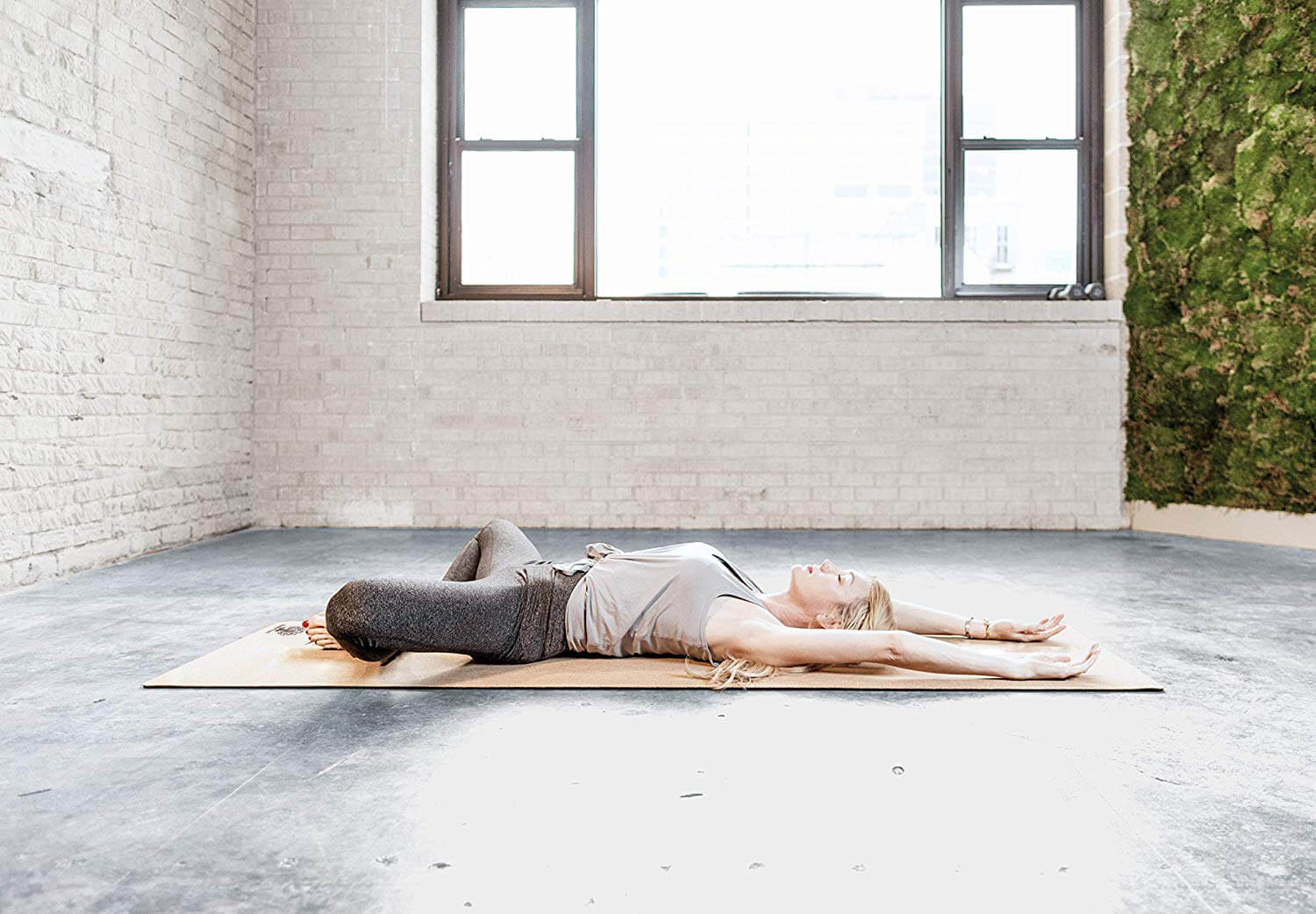 Woman resting on cork yoga mat